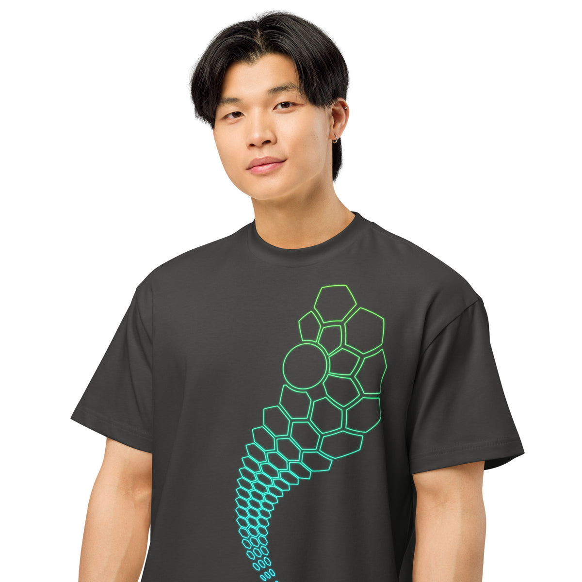 Hexa cotton box t-shirt in Vintage Black, detail on a model: large green cells and a circle shrinking into small hexagons