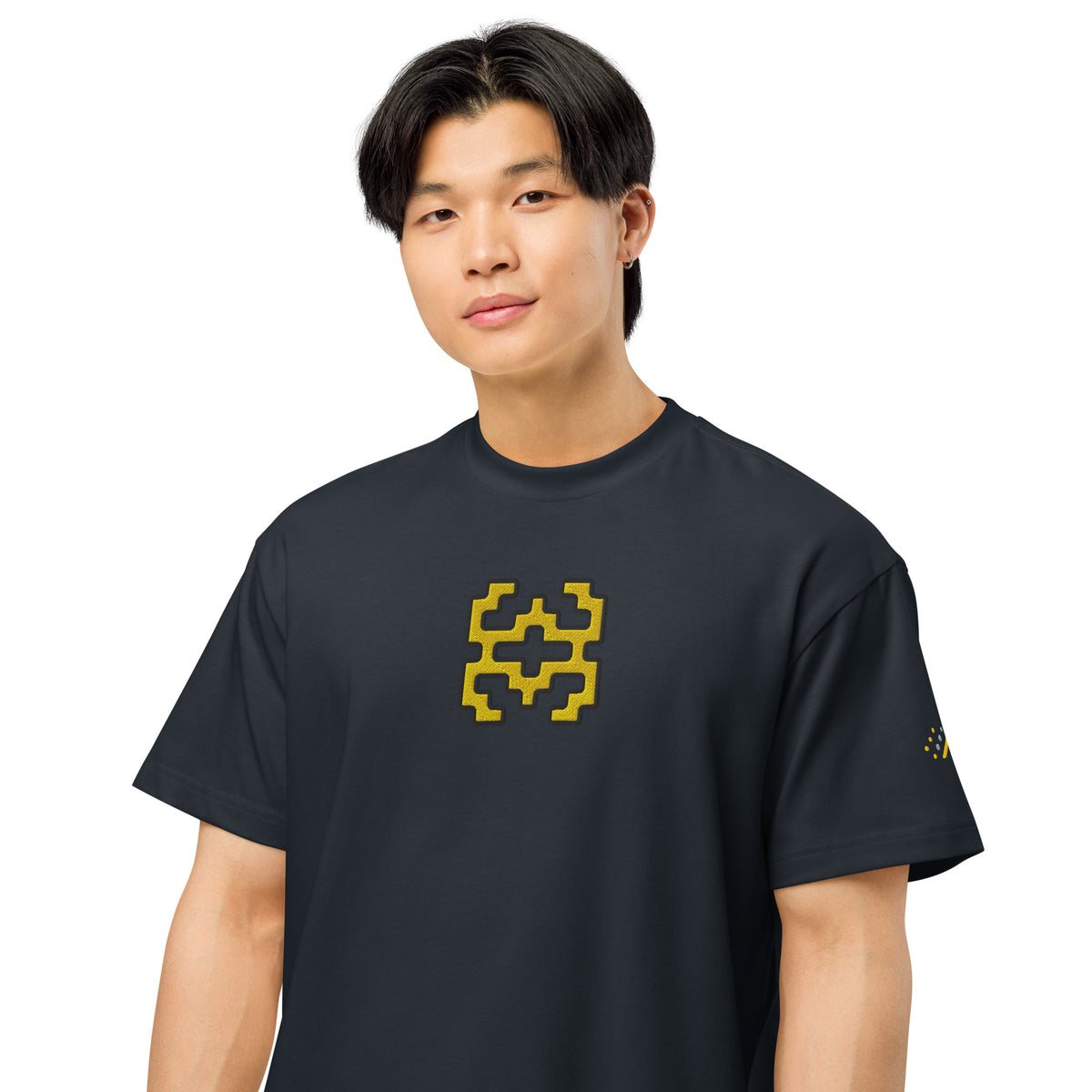 Invaders embroidered box tee in Navy Blazer, on a person, close: golden yellow figure on the chest, dot mark on left sleeve