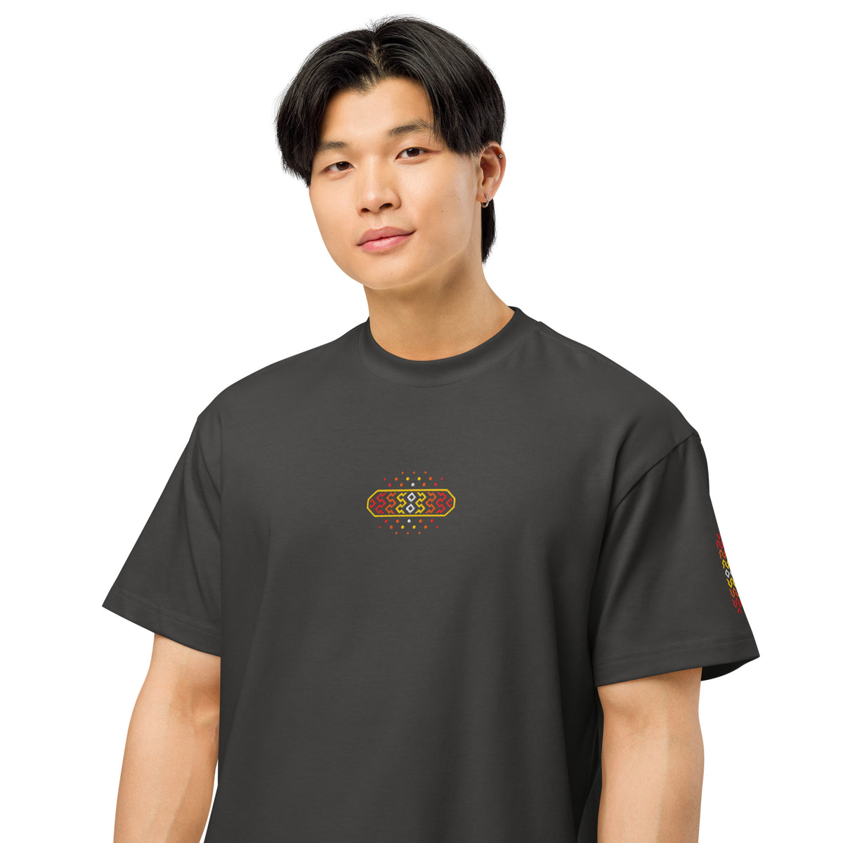 Invaders 2 embroidered box tee in Vintage Black, on a person, close: red to yellow hook badge with white diamonds