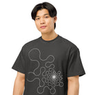 Metaball B&W cotton box t-shirt in Vintage Black, close front view on a model: rounded lobes tightening into a dense core