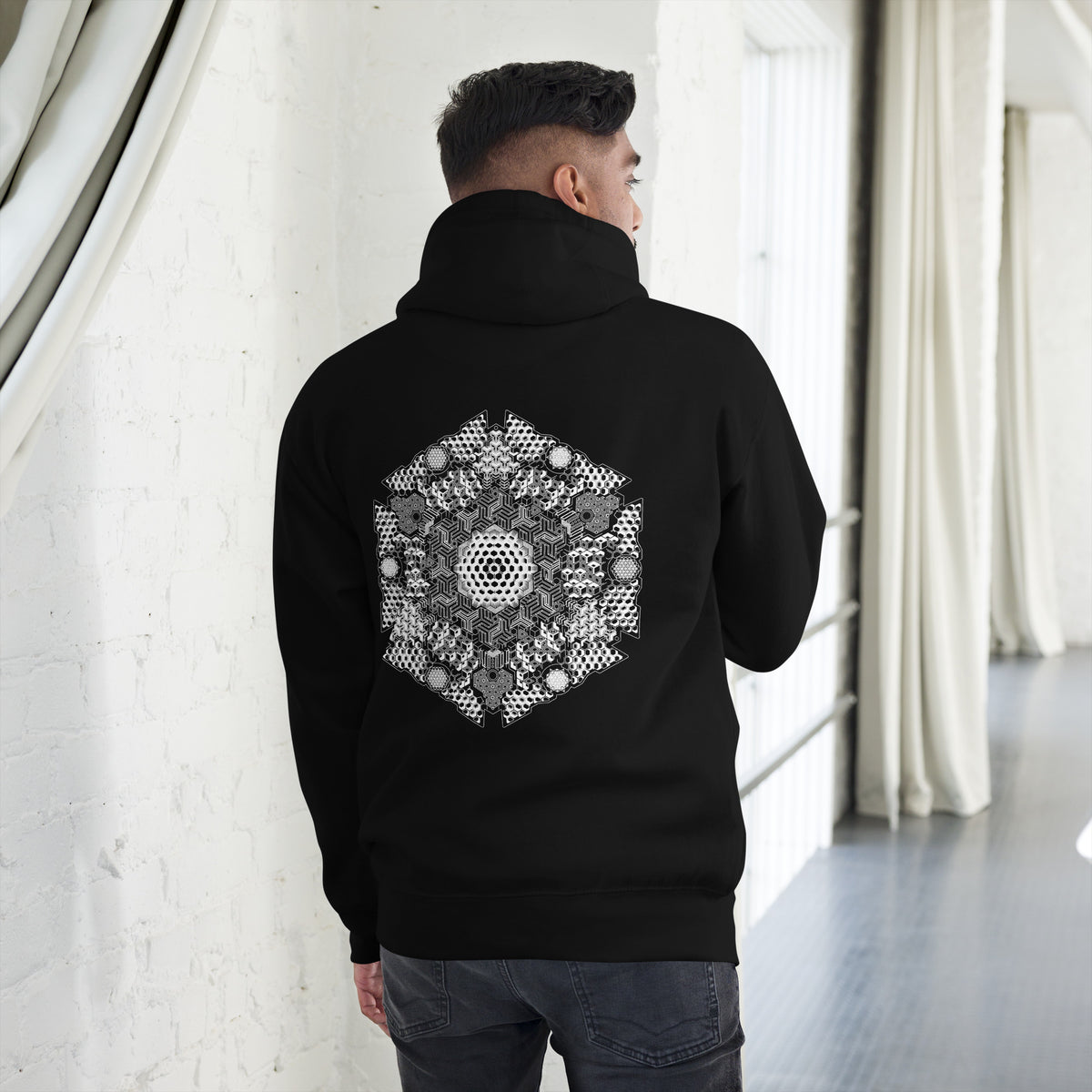 GeoDNA B&W unisex cotton hoodie in Black, back view on a model: large white hexagon artwork across the back